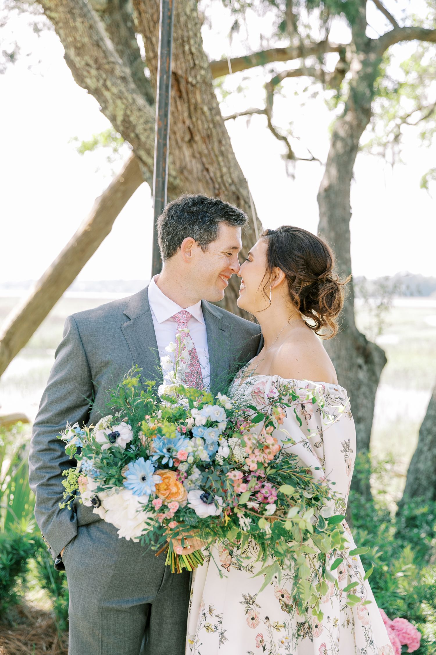 Romantic outdoor wedding photography showing delicate floral bouquet and lace details in natural lighting.