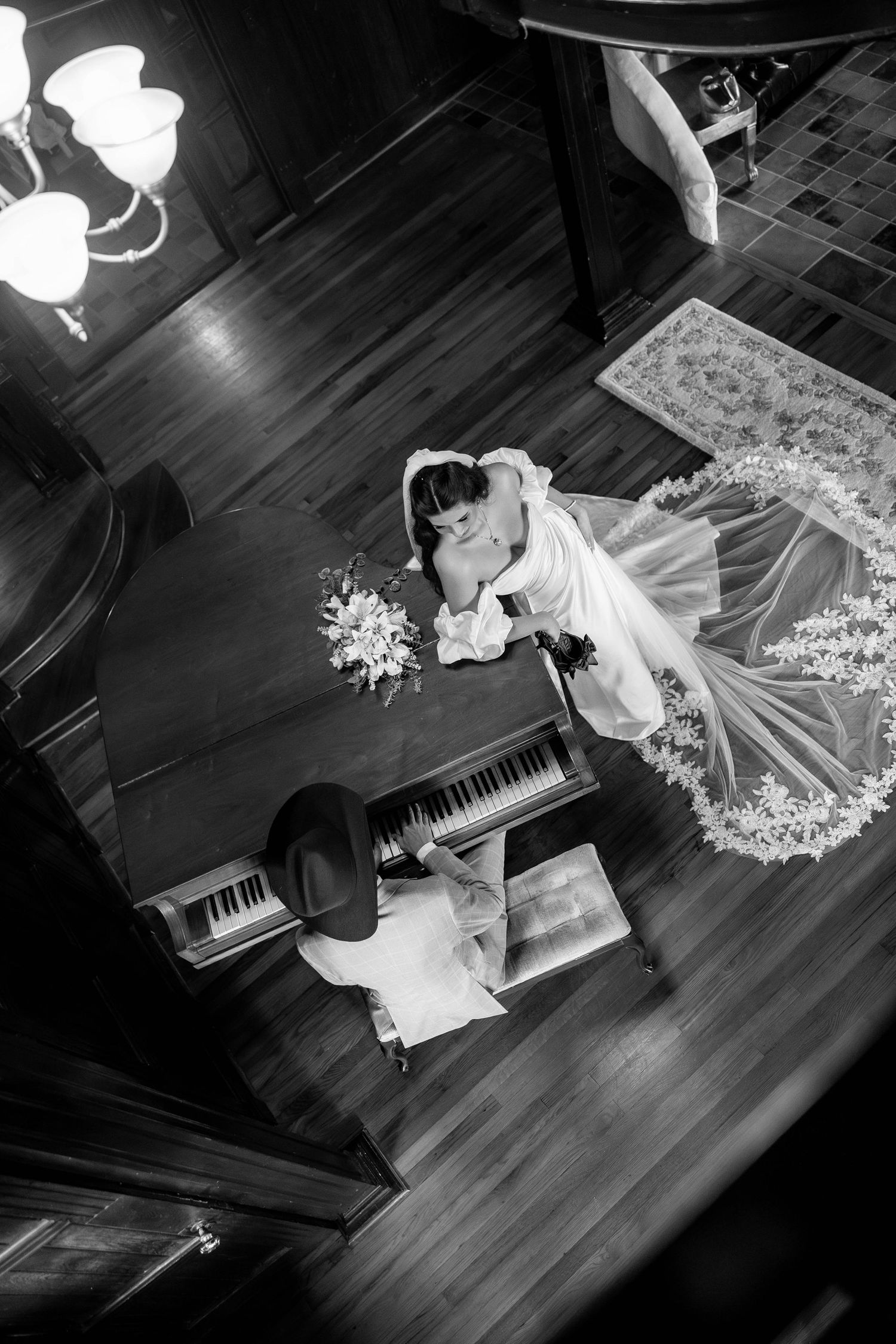 Black and white artistic photo series of a bride in a flowing white dress posing with a grand piano.
