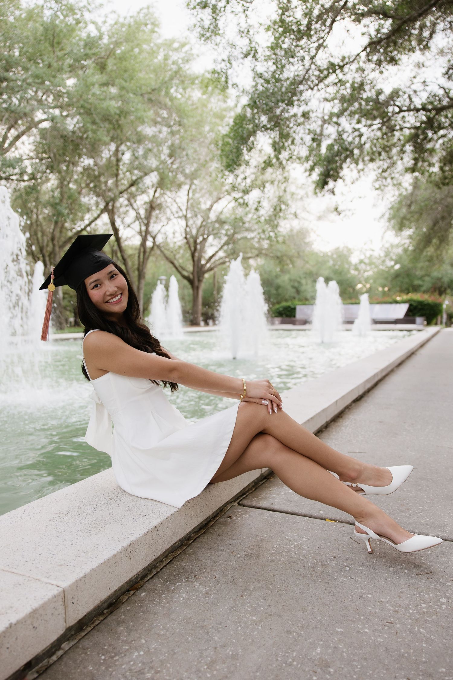 A USF grad is wearing her cap for her grad photos captured by Michaela Gom Photography.