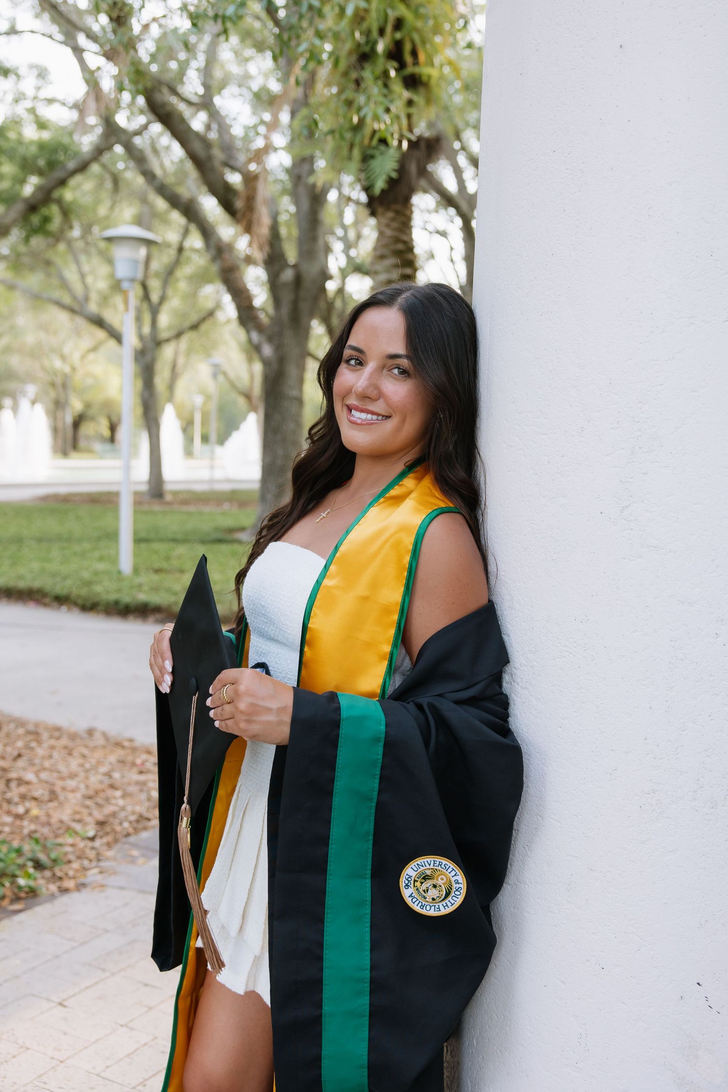A University of South Florida grad holds her cap for her grad photos captured by Tampa grad photographer Michaela Gom Photography.
