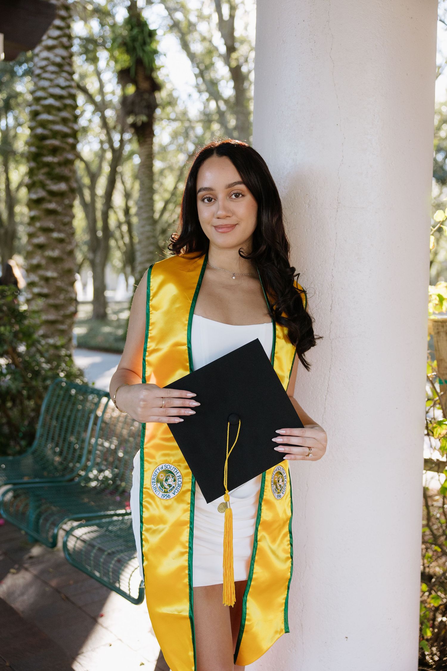 A University of South Florida grad holds her cap for her grad photos captured by Tampa grad photographer Michaela Gom Photography.