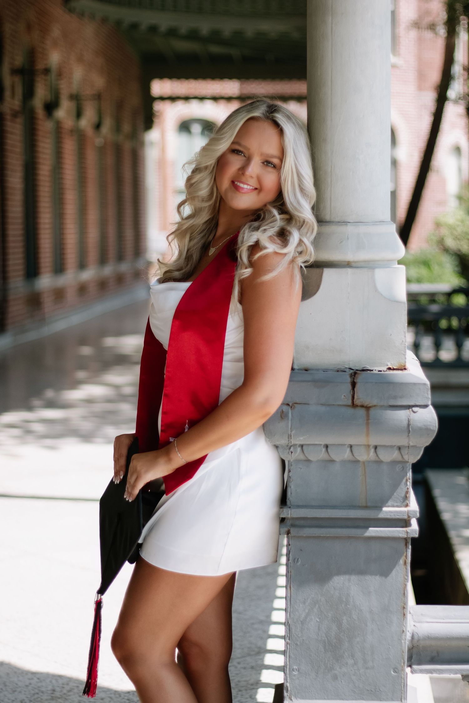 A University of Tampa graduate poses for her grad photos at captured by Tampa grad photographer Michaela Gom Photography.