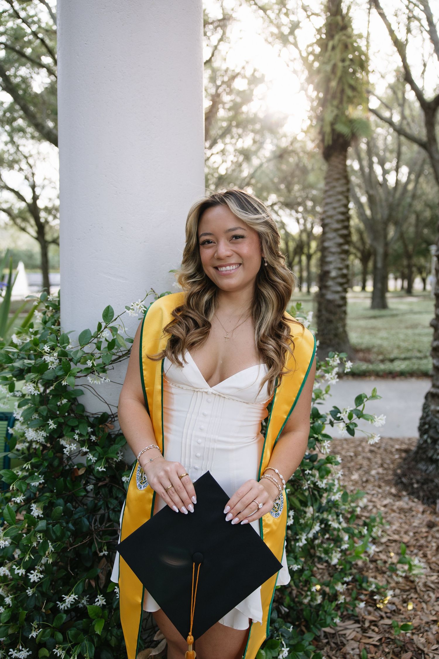 A USF student stands by a pillar at USF captured photographer Michaela Gom Photography.