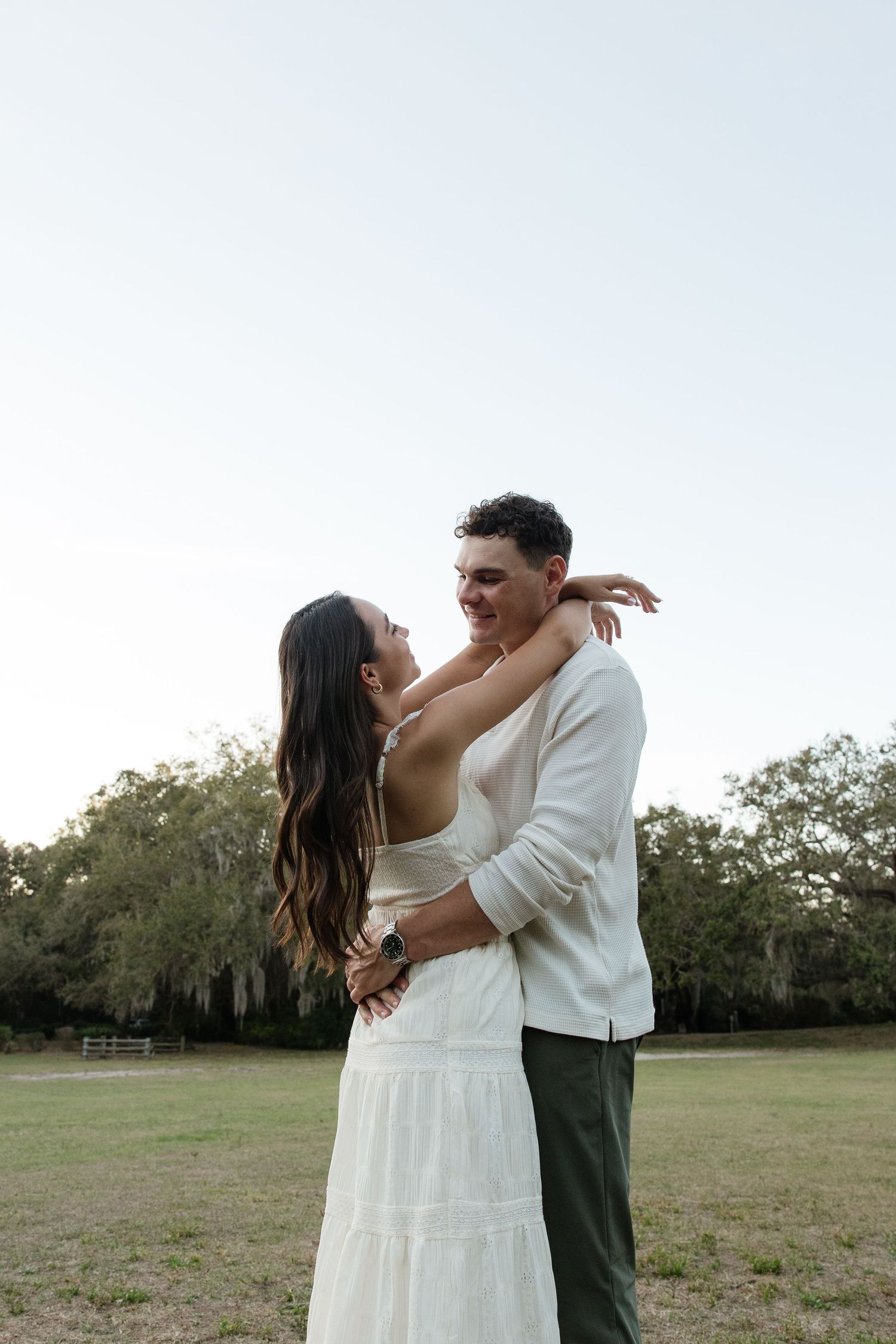 An engaged couple from Tampa are dancing together at Philippe park captured by Michaela Gom Photography.
