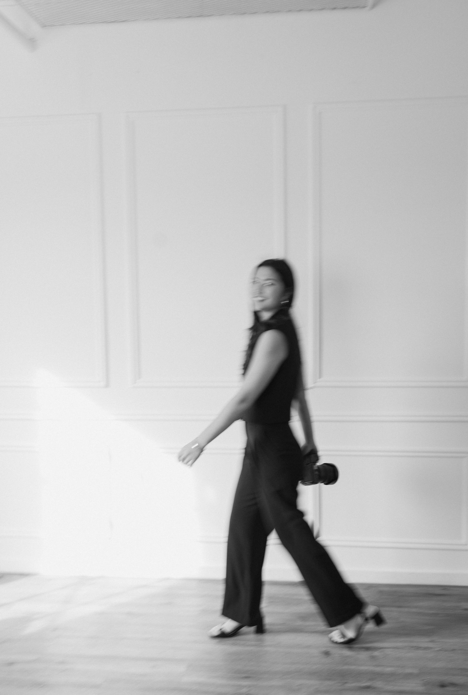 The photographer Michaela Gom Photography is walking in her branding photos captured in black and white, taken by Jadyn Shea Photography