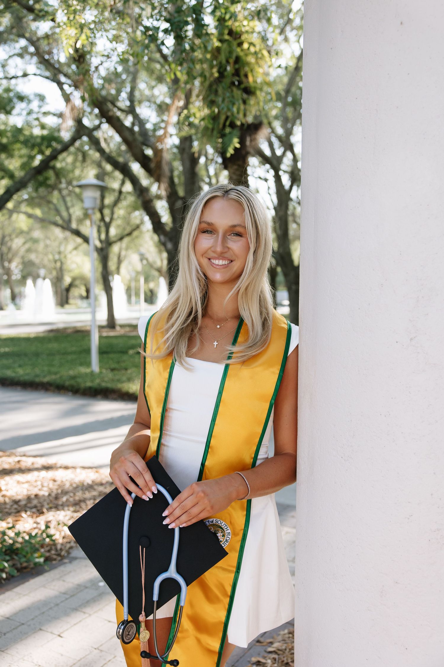 A University of South Florida graduate holds her cap for her grad photos captured by Tampa grad photographer Michaela Gom Photography.