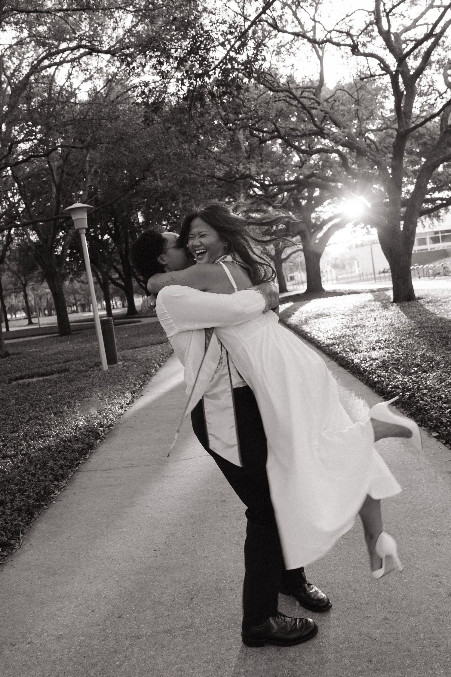 Two USF grad students are hugging in their graduation photos taken by Michaela Gom Photography.