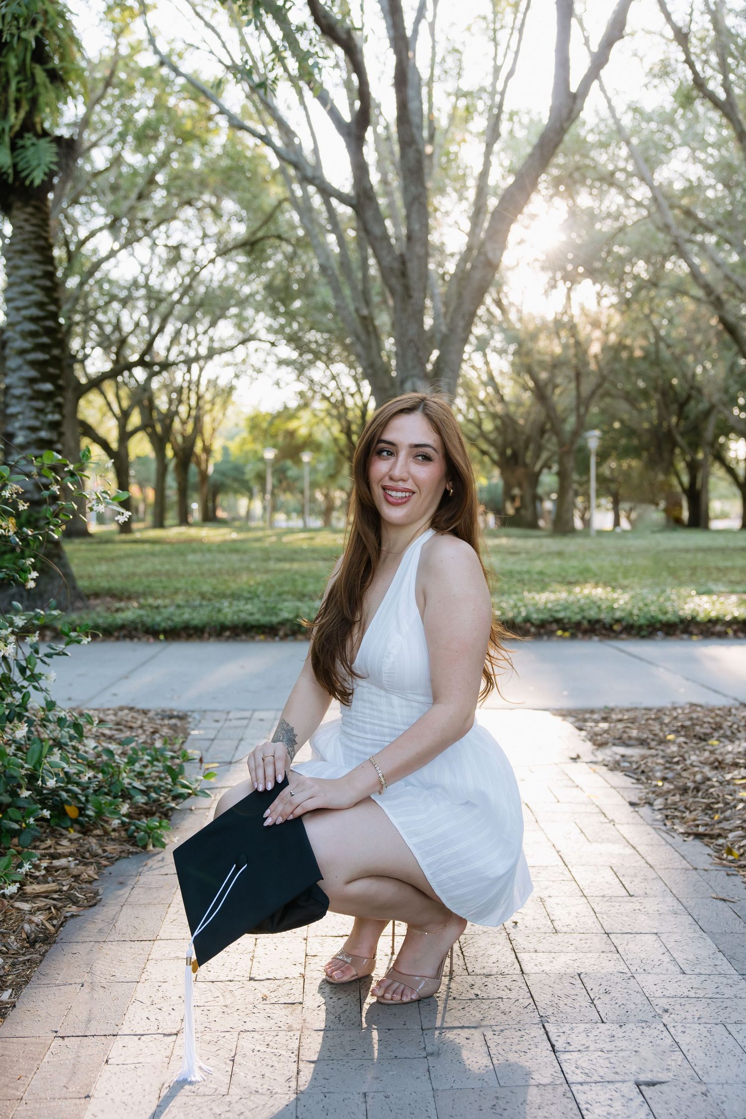 A University of South Florida graduate is posing with her cap captured by Tampa grad photographer Michaela Gom Photography.