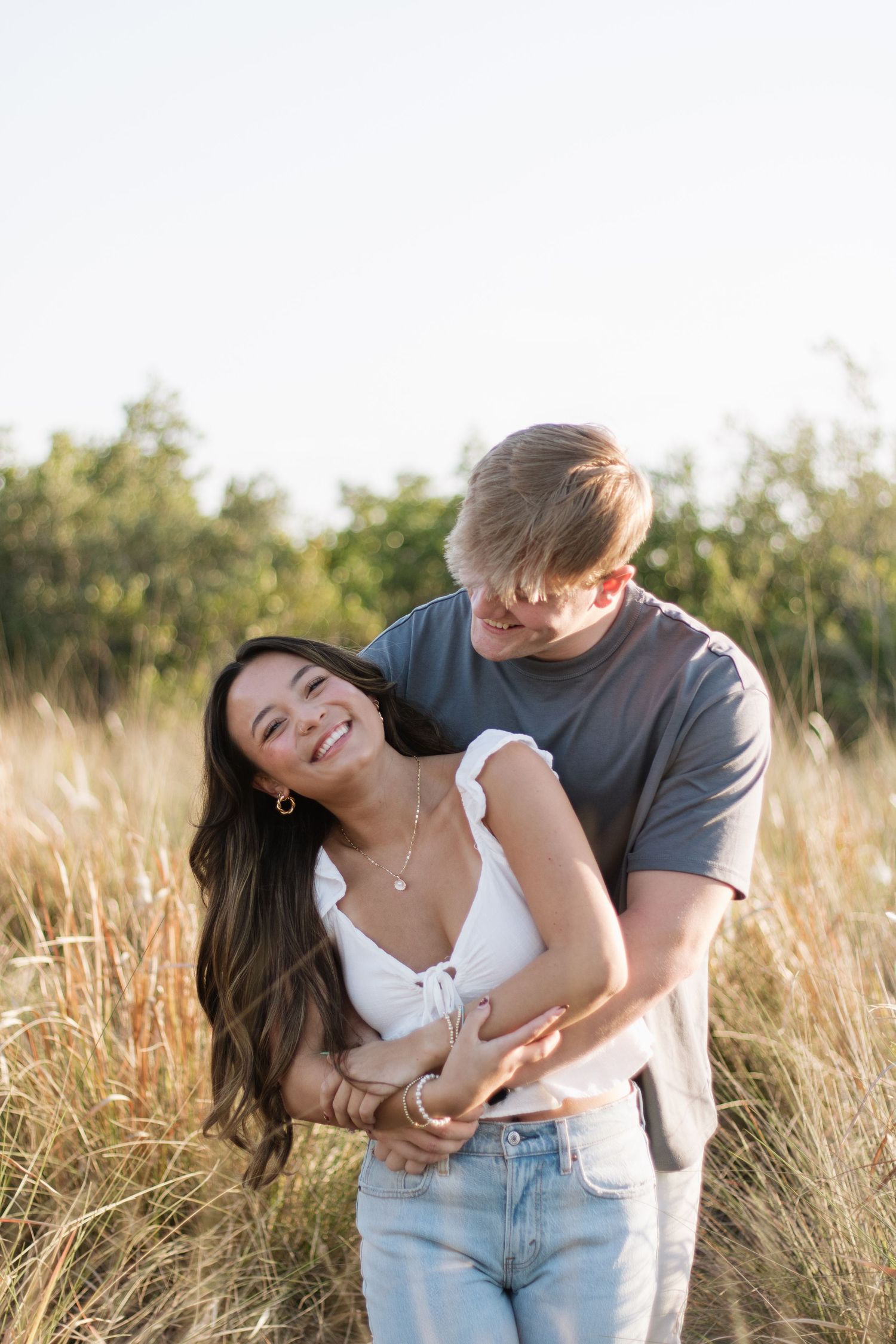 Young love at Cypress Point Park celebrating their love captured by Michaela Gom Photography.