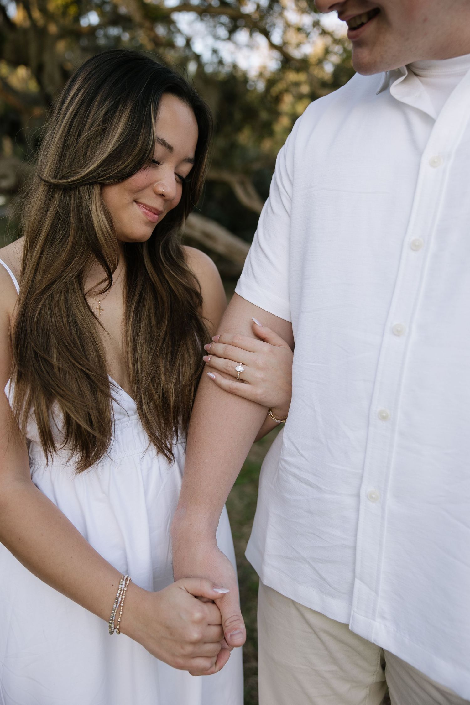 A Tampa couple are hugging at Philippe park captured by Michaela Gom Photography.