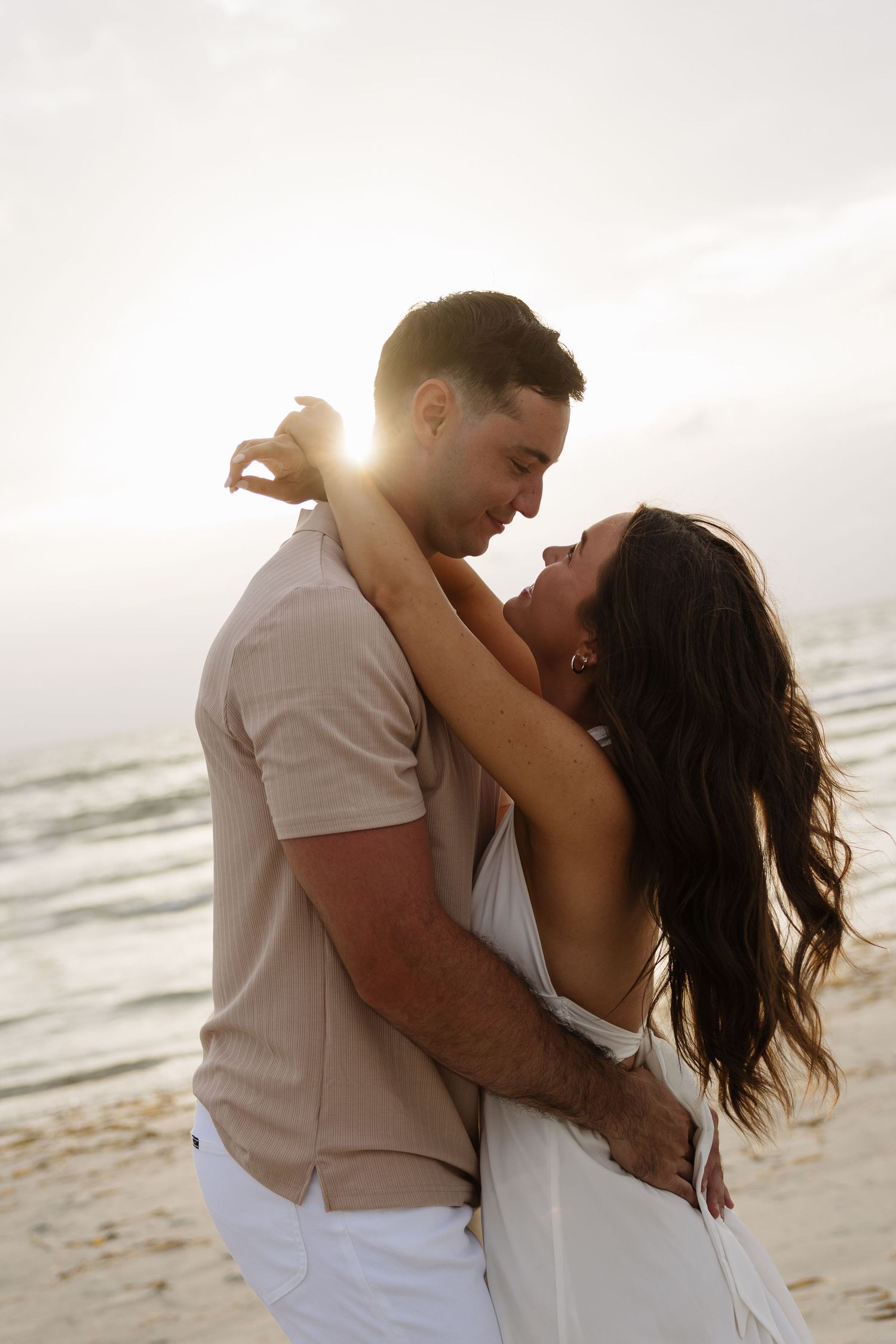 Engaged couple looks at each other. Captured by timeless and true to color Tampa Michaela Gom Photography.