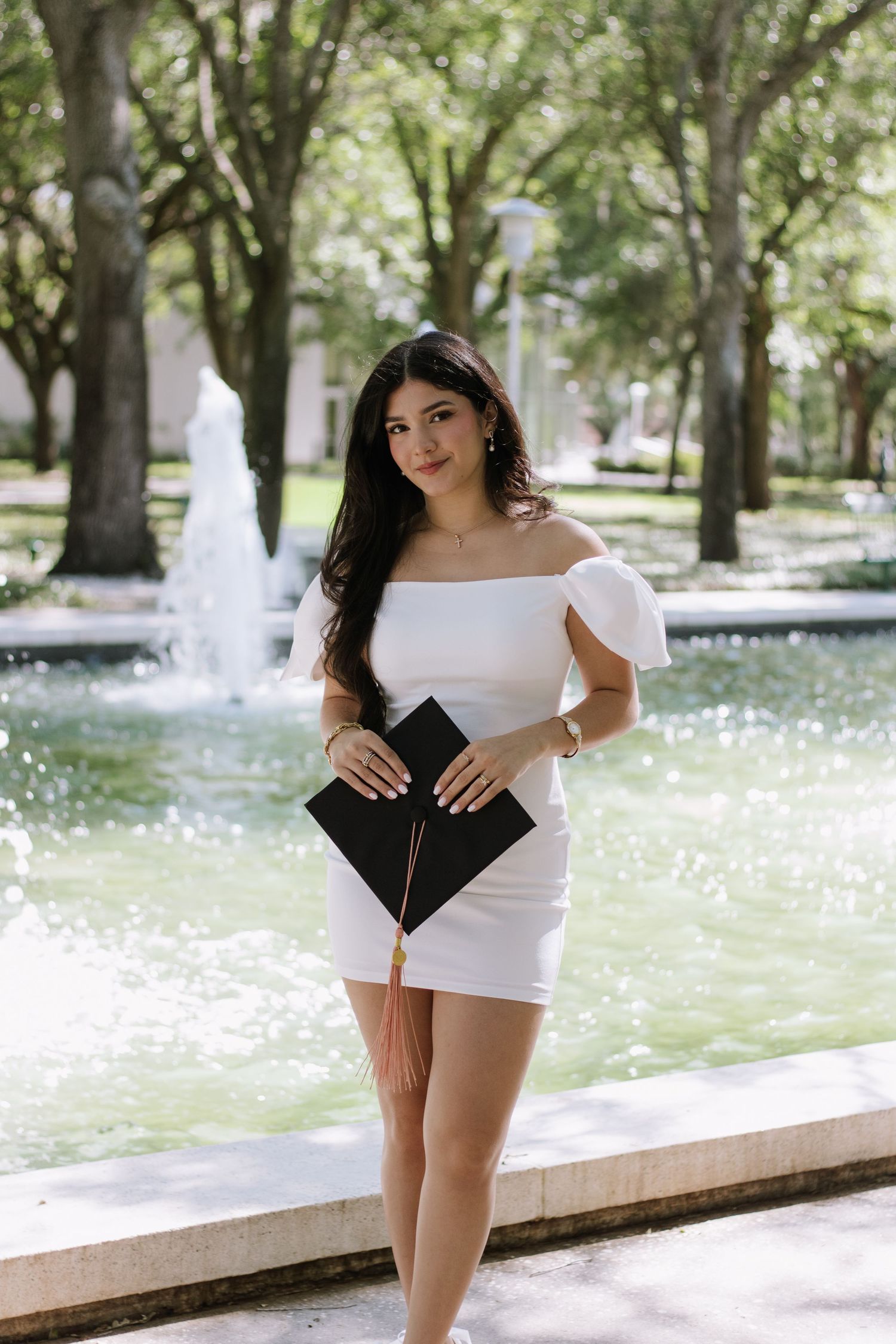 A University of South Florida graduate poses holding her cap captured by Tampa grad photographer Michaela Gom Photography.