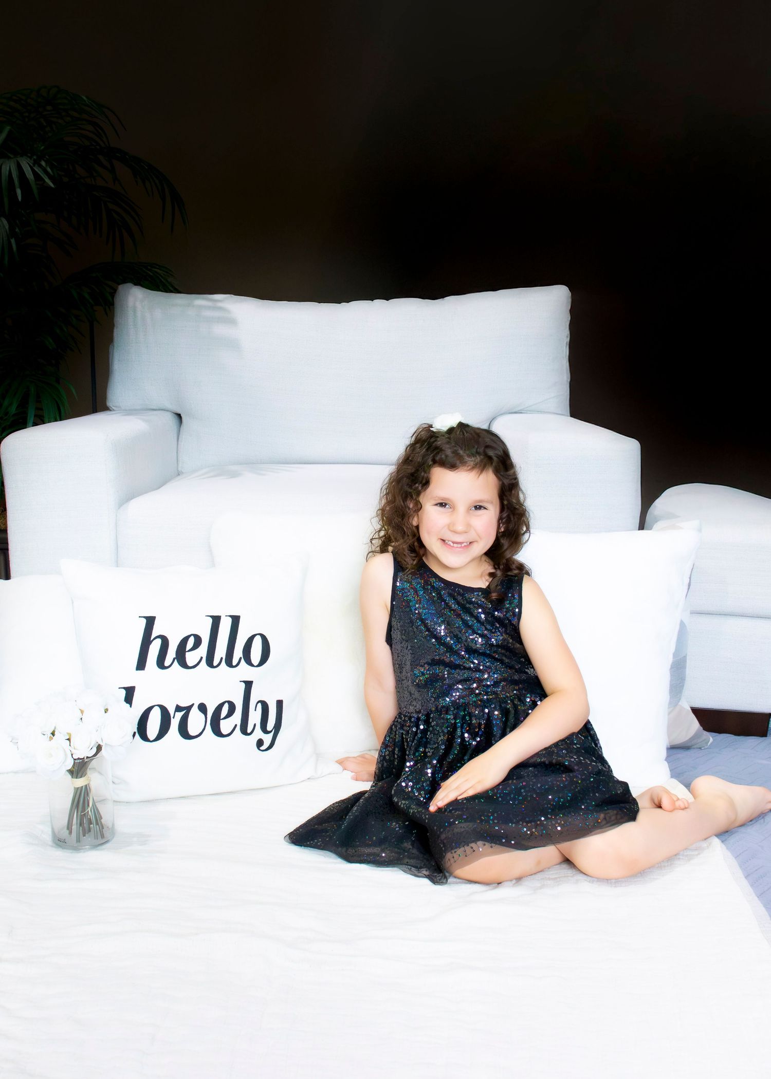 White couch with decorative pillows showing hello text in modern living room setting.