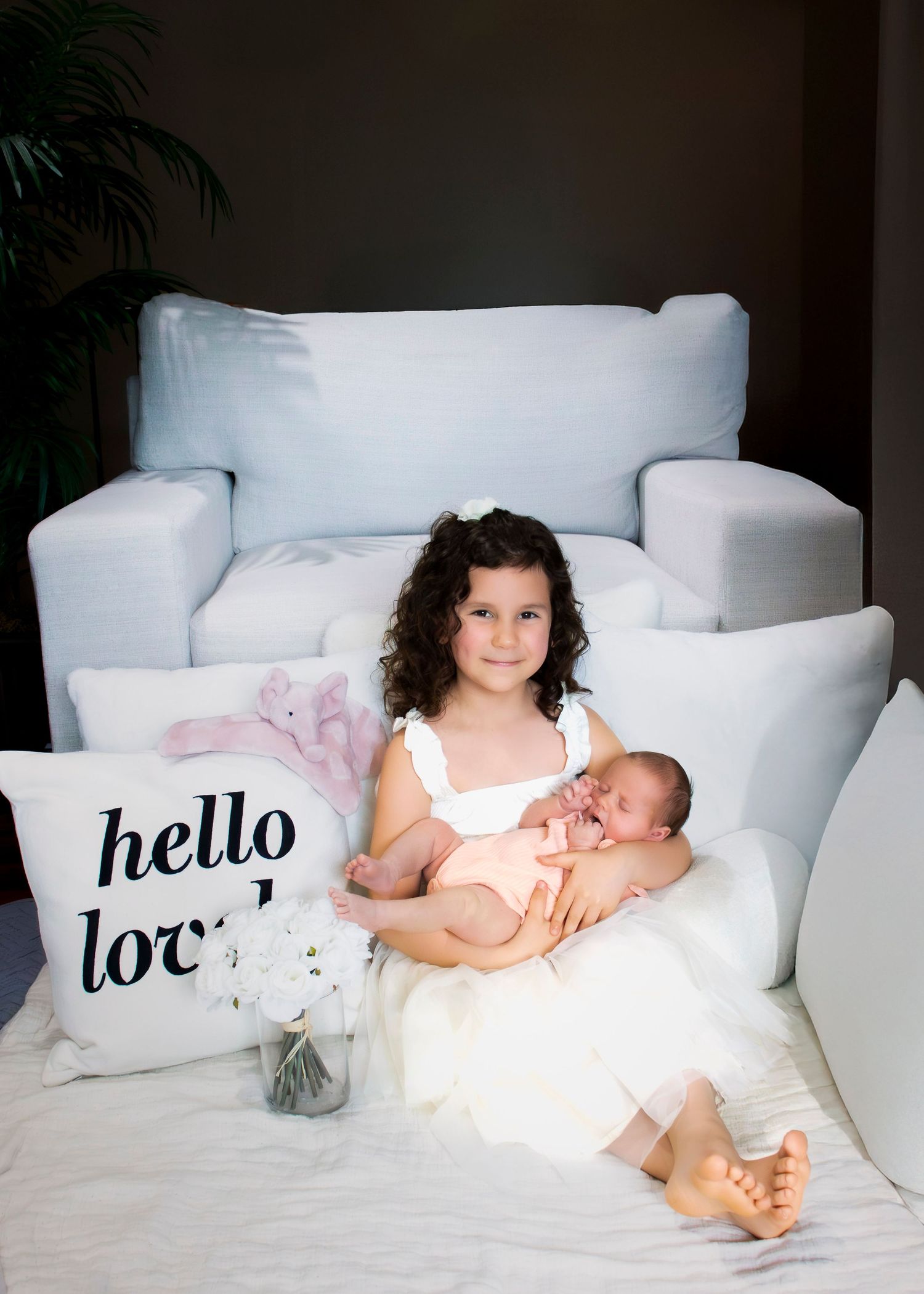 White couch with hello text pillows arranged in contemporary living room setting.