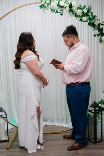 Wedding couple poses in multiple romantic shots against a white backdrop with green floral decorations.