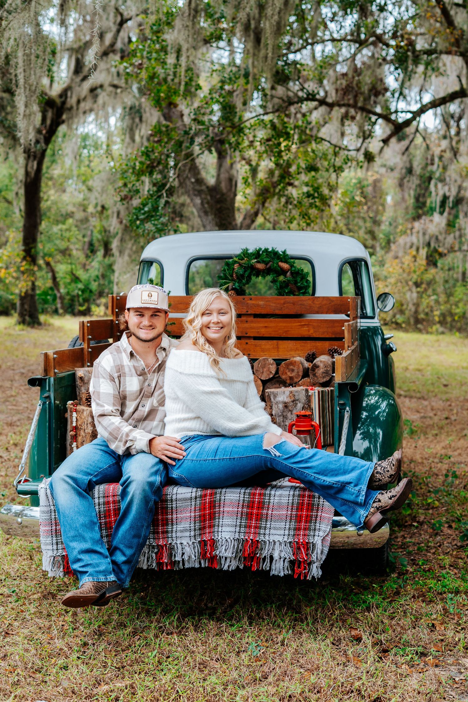 Couple relaxing on outdoor swing with plaid blanket and rustic decor.