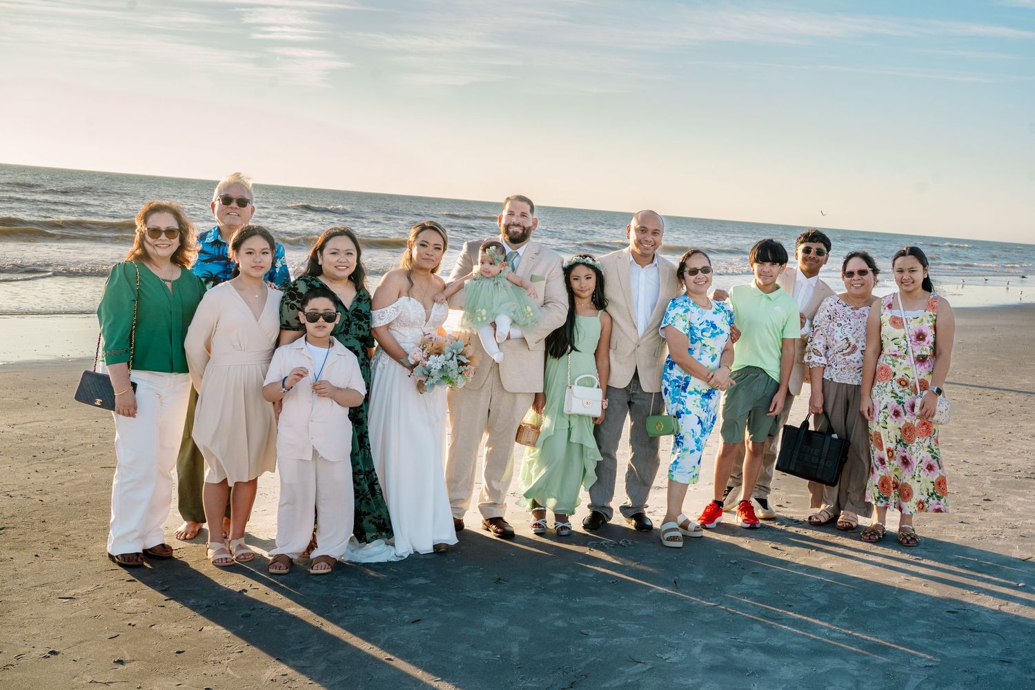 A group of people standing together on a beach during sunset creating a panoramic collage effect.