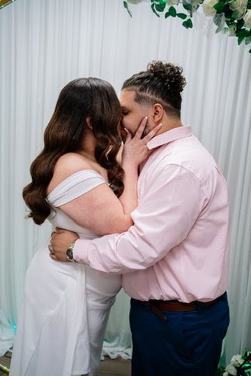 Romantic couple in pink and white attire sharing intimate kisses in sequence against white curtain backdrop.
