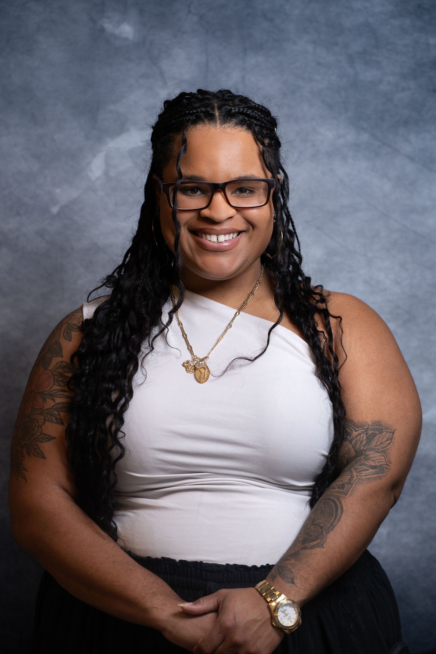 Professional studio portrait series showing someone in a white tank top and glasses against a textured gray background.