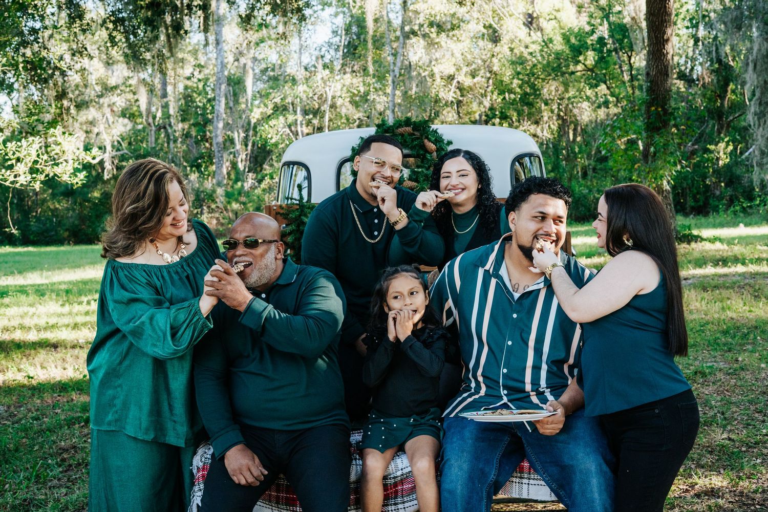 Candid group photo showing joyful interactions between family members in coordinated outfits.