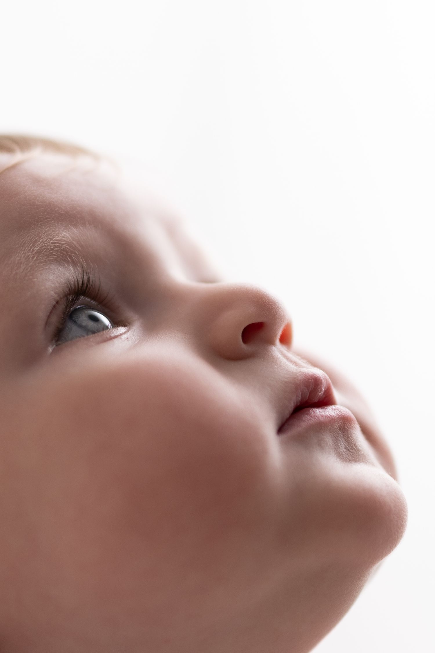 Close-up artistic series showing a person's nose and lips from different angles in soft lighting.