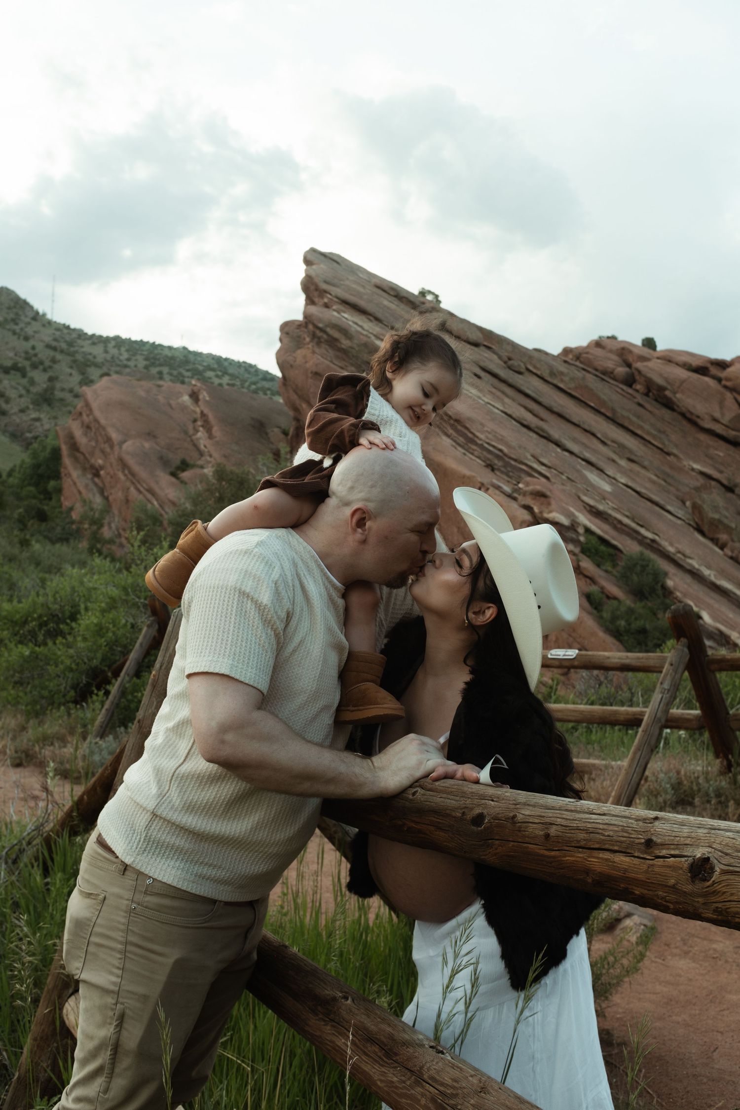 An intimate family moment captured against the backdrop of scenic red rocks.
