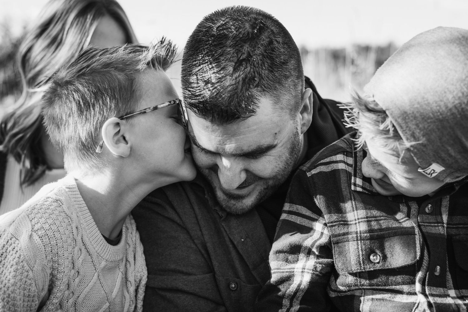 Black and white photo sequence showing a couple in intimate poses expressing tenderness and affection.