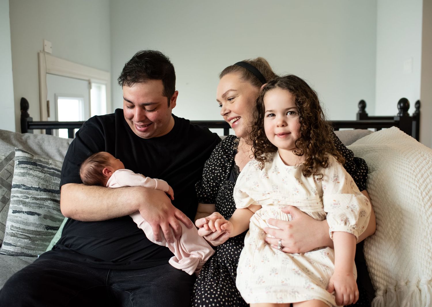 A collection of intimate family portraits showing tender moments between parents and baby in a bright indoor setting.