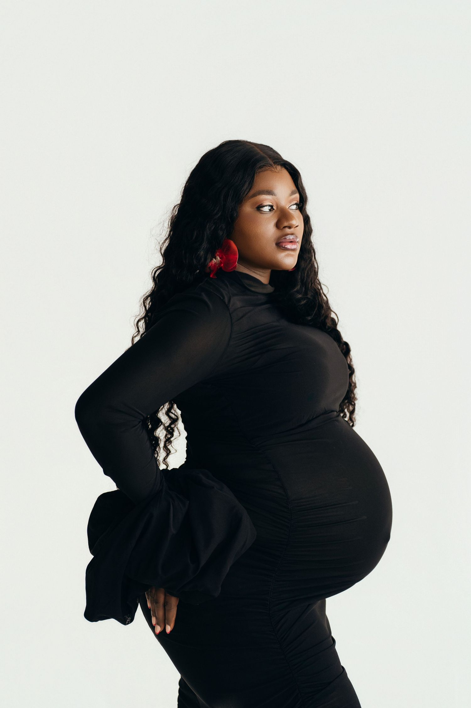A person wearing a black sweater poses expressively against a white background in a dynamic photo series.