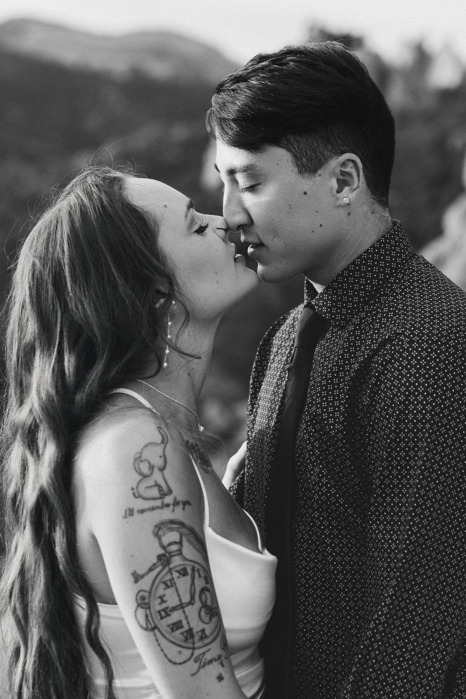 A black and white photo series showing an intimate couple sharing romantic kisses.