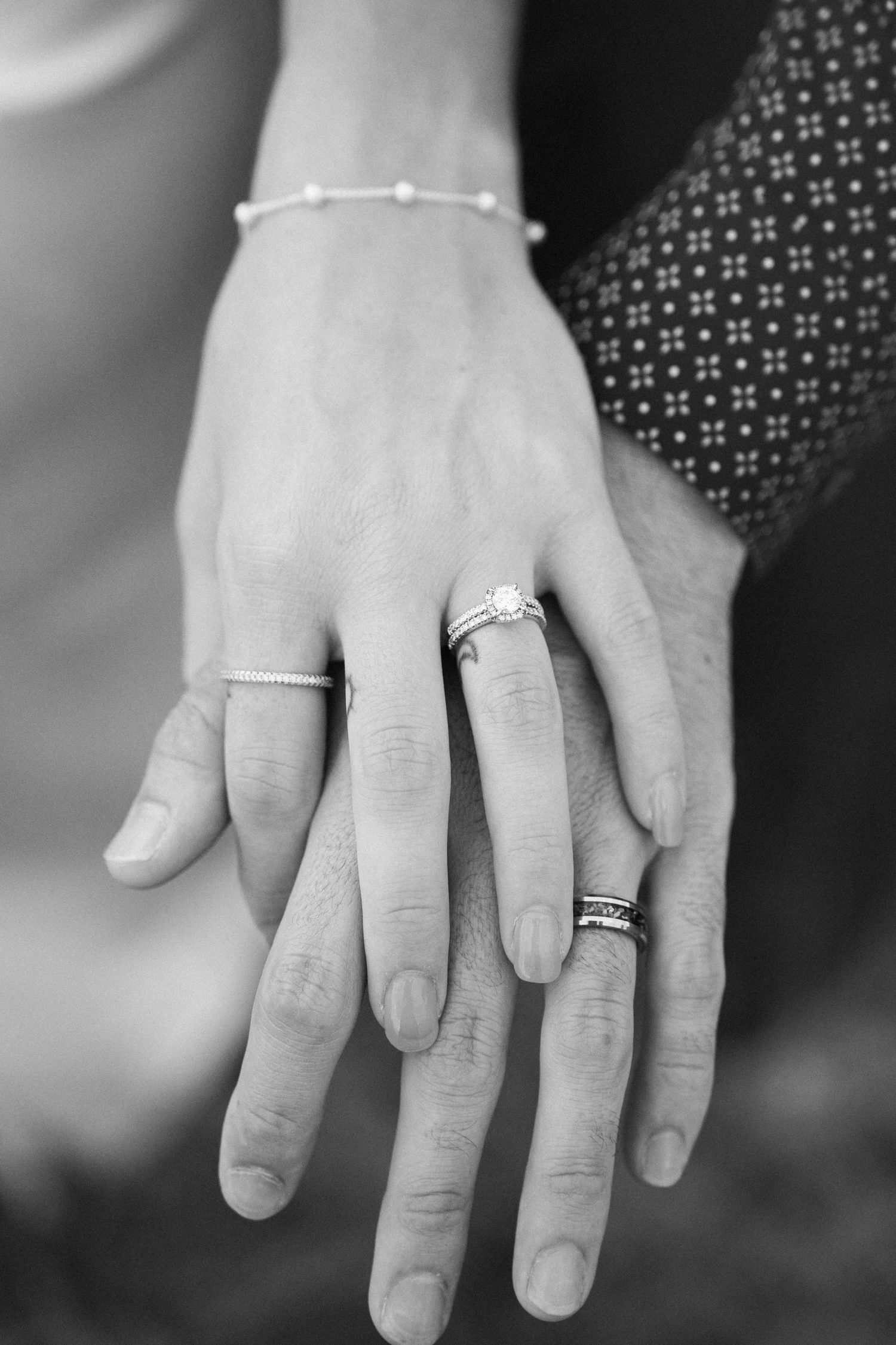 A series of black and white close-up shots showing hands wearing wedding rings.