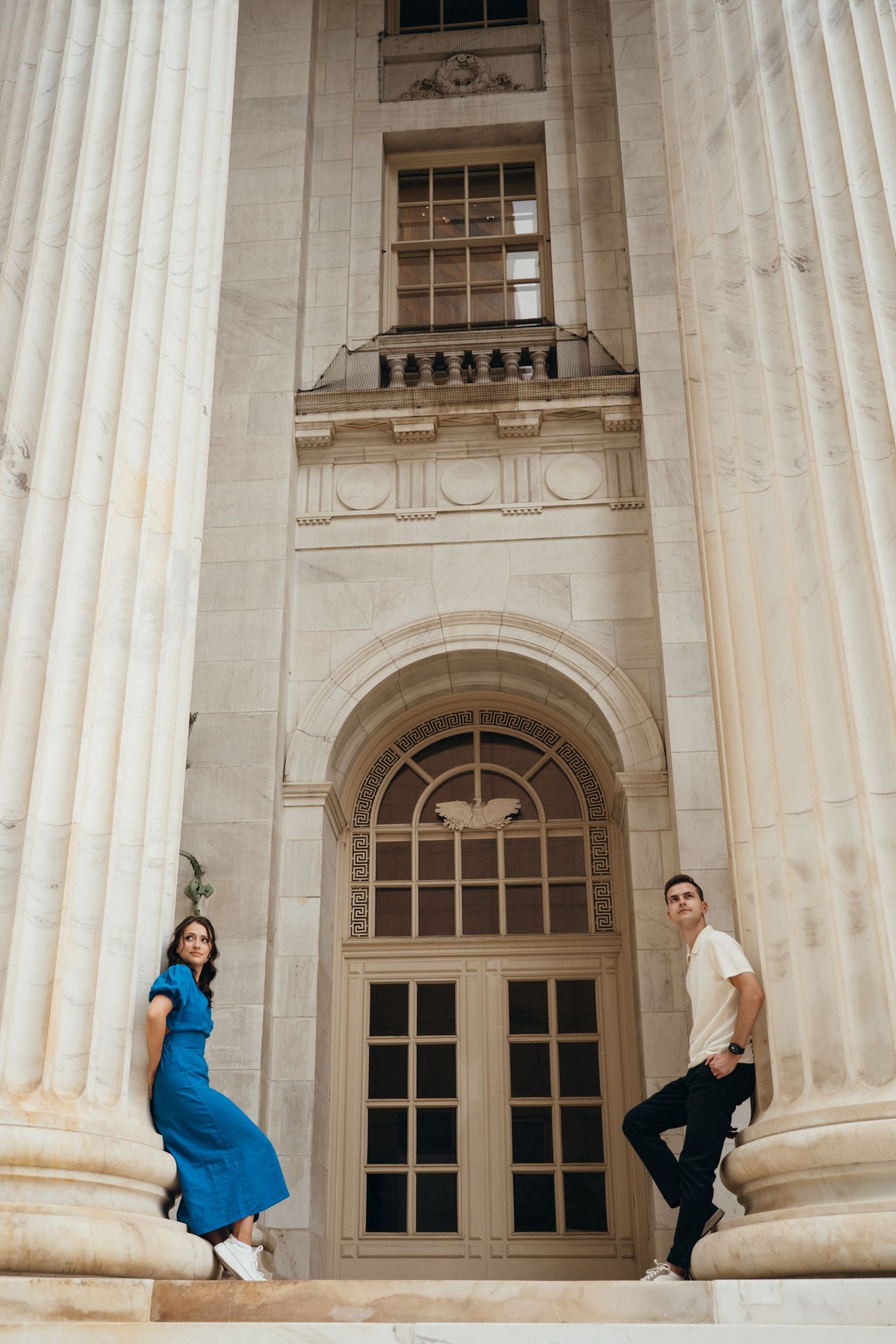 Three artistic portraits against white stone columns show people posing at different angles in a classical architectural setting.