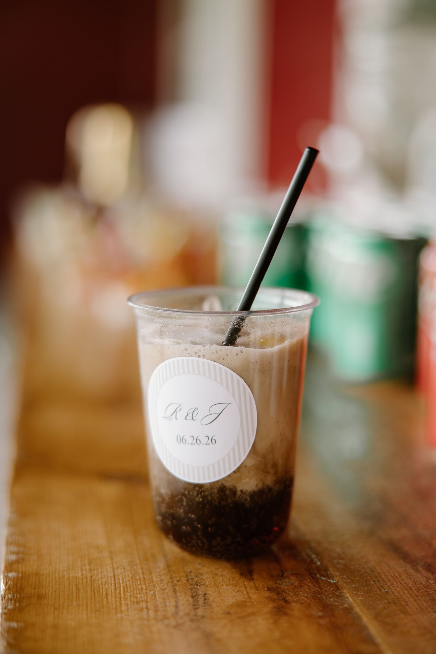 Custom wedding favor iced drink in plastic cup with monogram label and date 06.26.26.