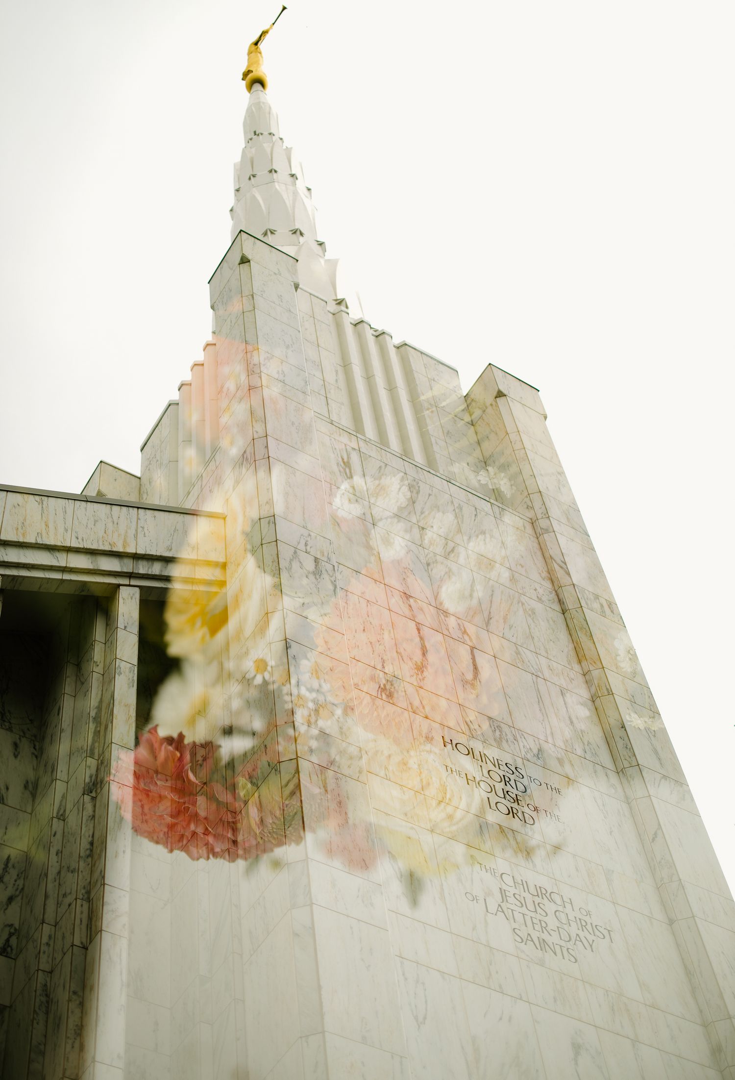 Double exposure photo of an LDS temple spire with angel Moroni statue blended with soft floral overlay.