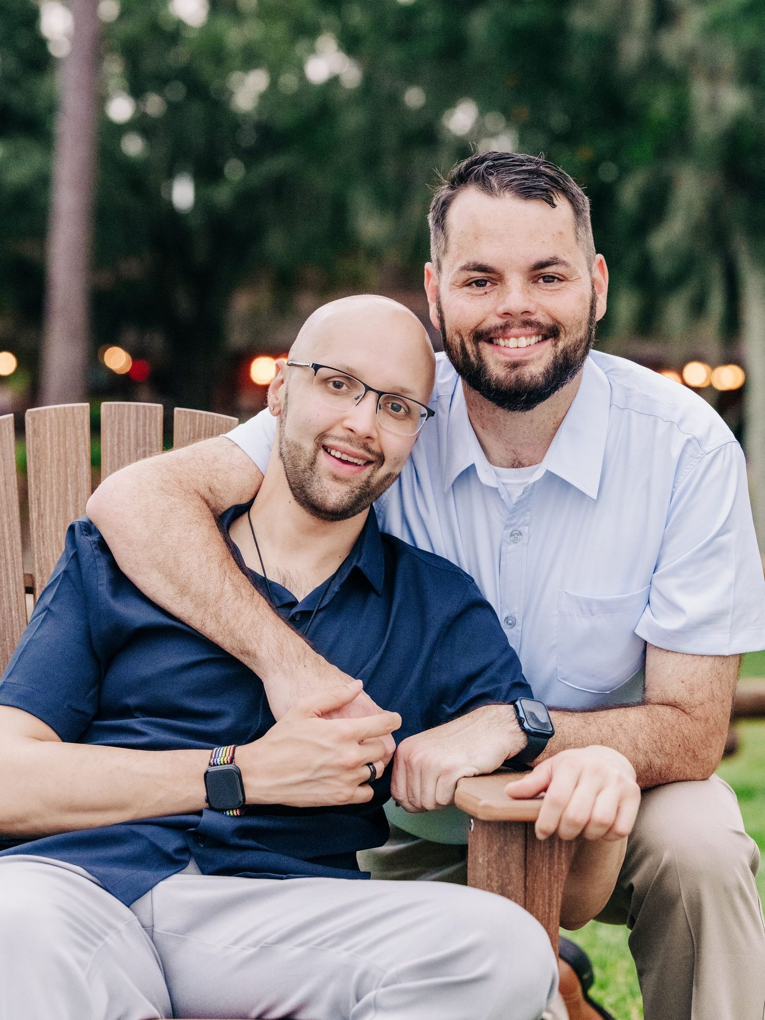 Couple smiling on patio furniture at dusk at Disney's Wilderness Lodge, Orlando engagement and proposal photography