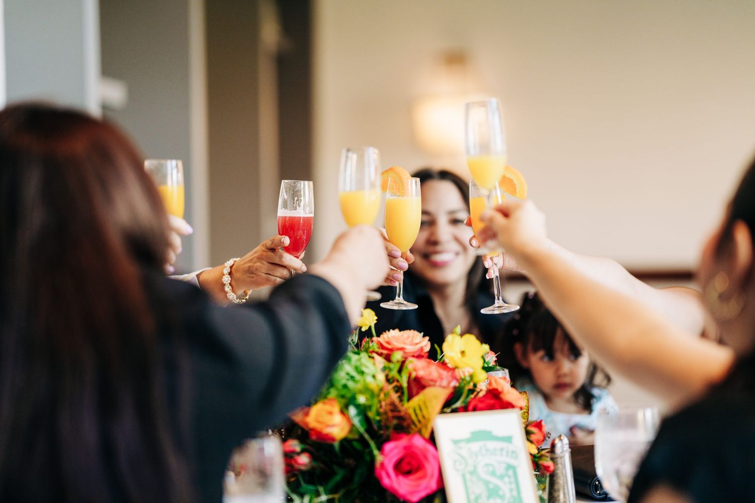 Guests raising champagne glasses at a bridal shower at Wyndham Grand Orlando Resort Bonnet Creek, Orlando event photography