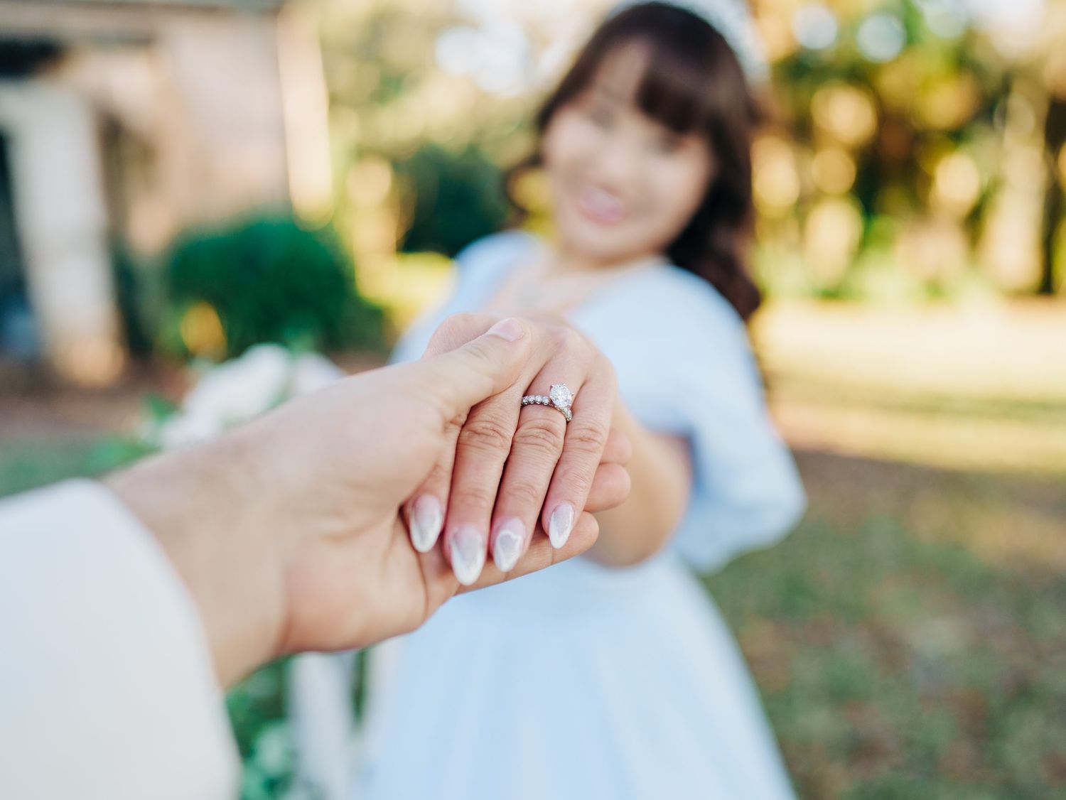 Close-up of an engagement ring in the sunlit gardens at Bok Tower Gardens in Lake Wales, Florida engagement photography