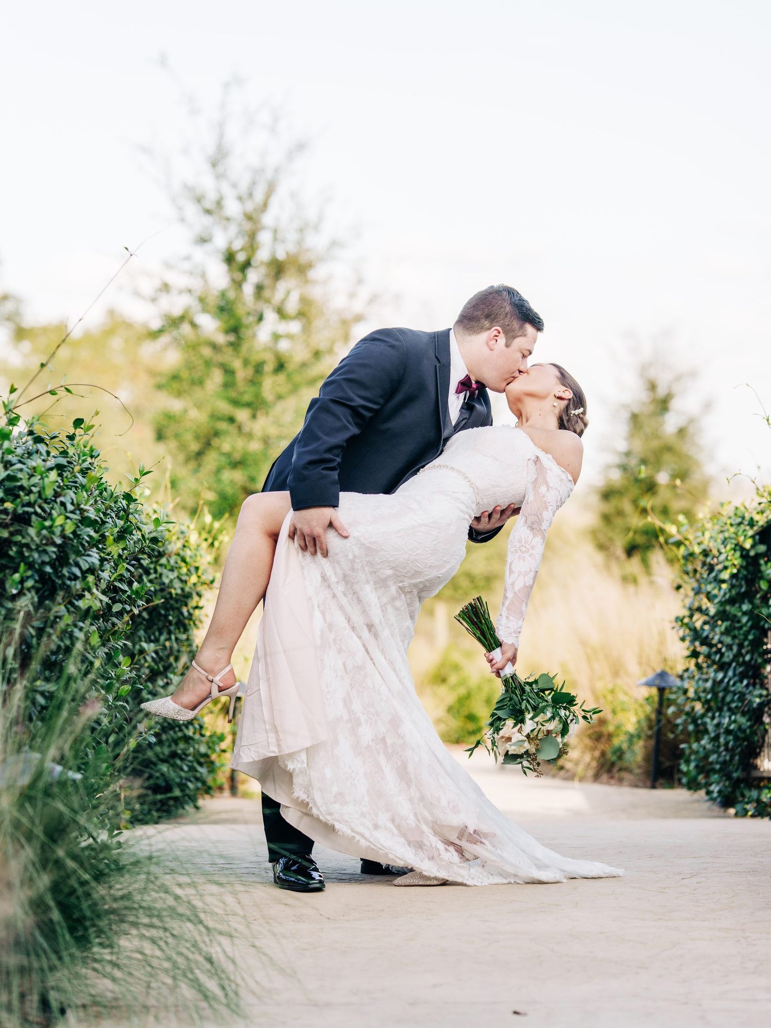 Groom lifting the bride outside Sterling Event Venue in Minneola, Florida, Central Florida wedding photography