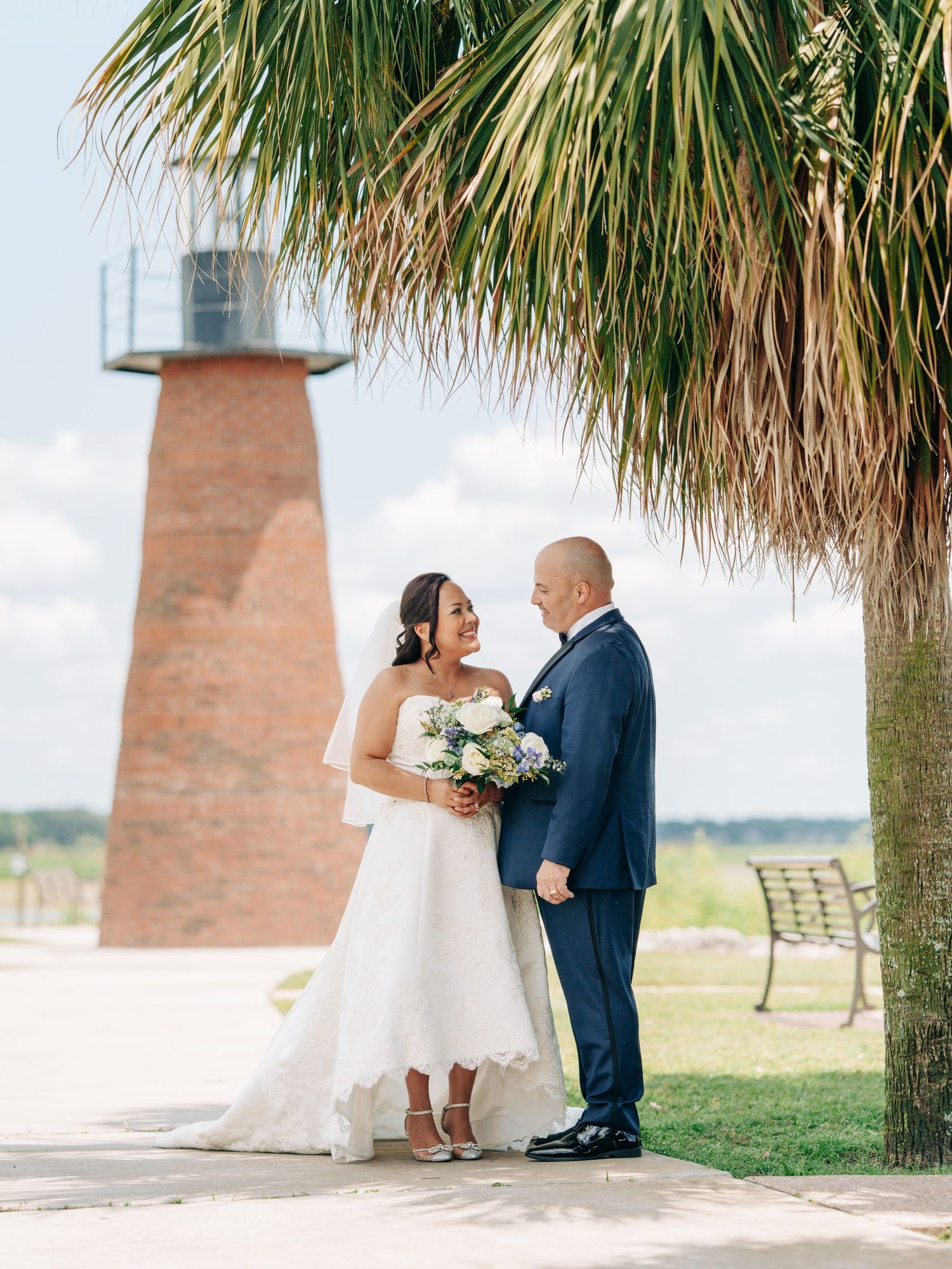 Newlyweds kissing by the lighthouse at Kissimmee Lakefront Park, Kissimmee, Florida, Orlando wedding photographer