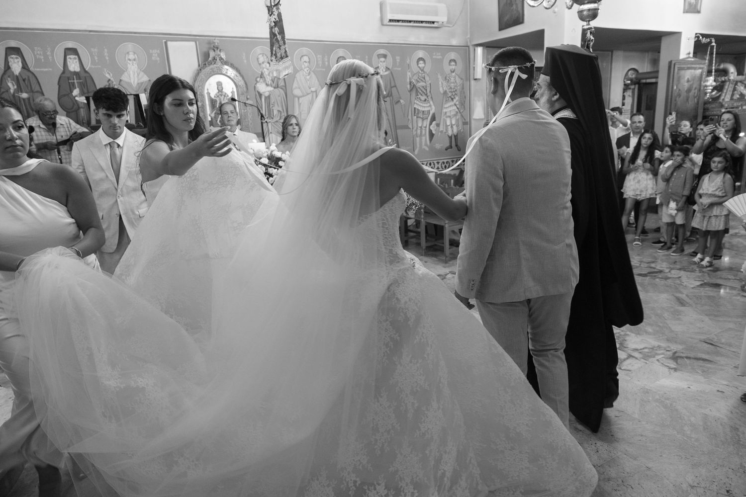 Wedding guests dance and celebrate on a lively dance floor during an indoor reception party.