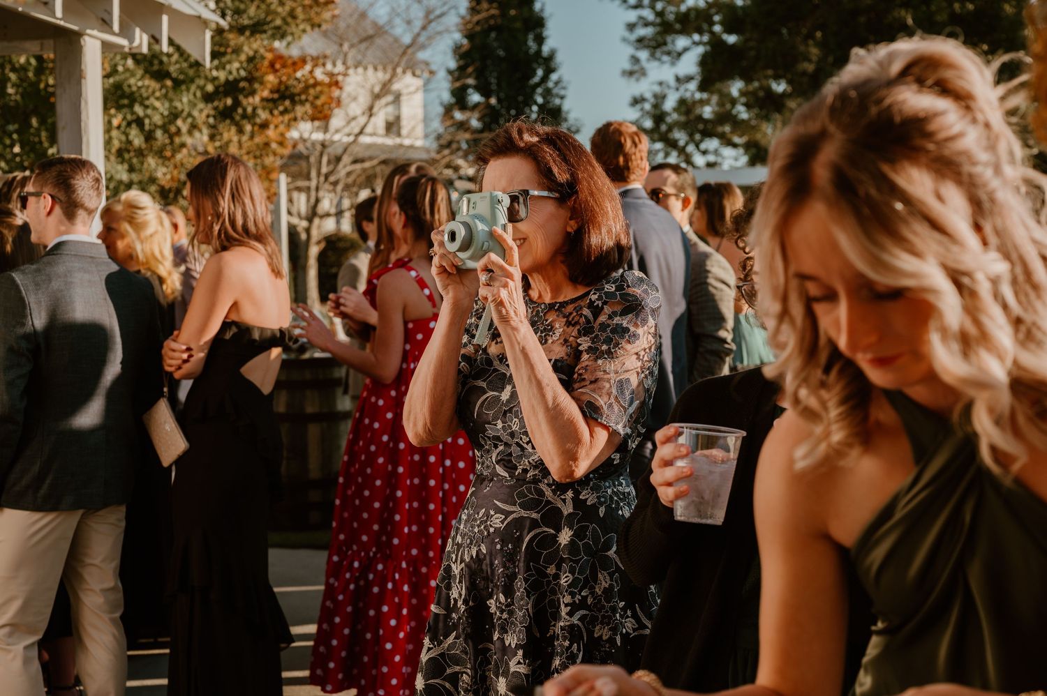 Wedding reception guests enjoying themselves at an outdoor celebration.
