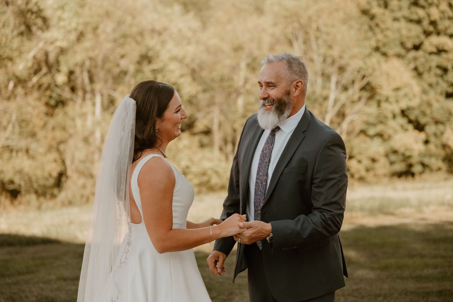 Outdoor wedding ceremony moment during golden hour.