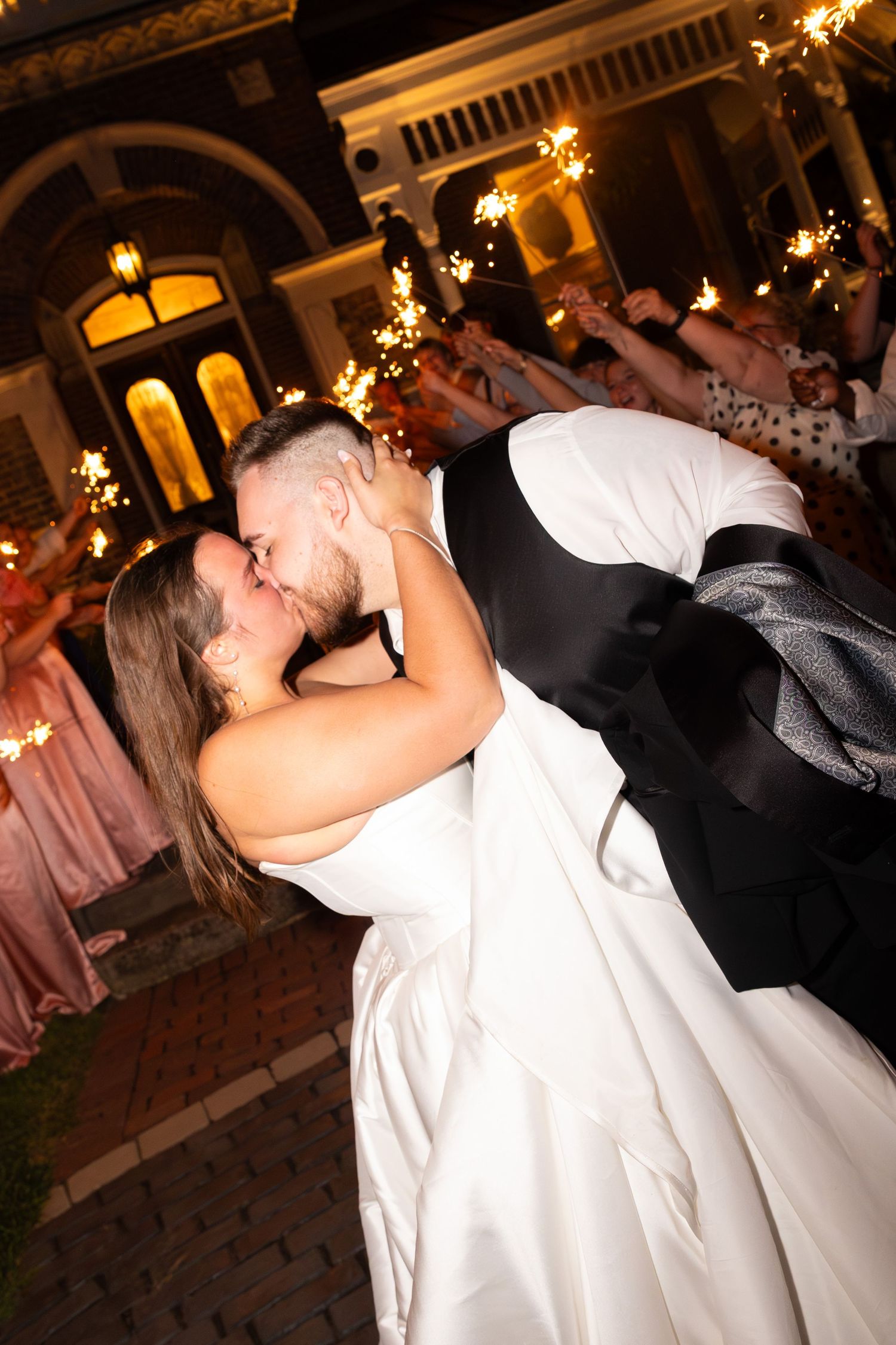 A romantic first dance moment captured under warm lighting at an elegant wedding reception.