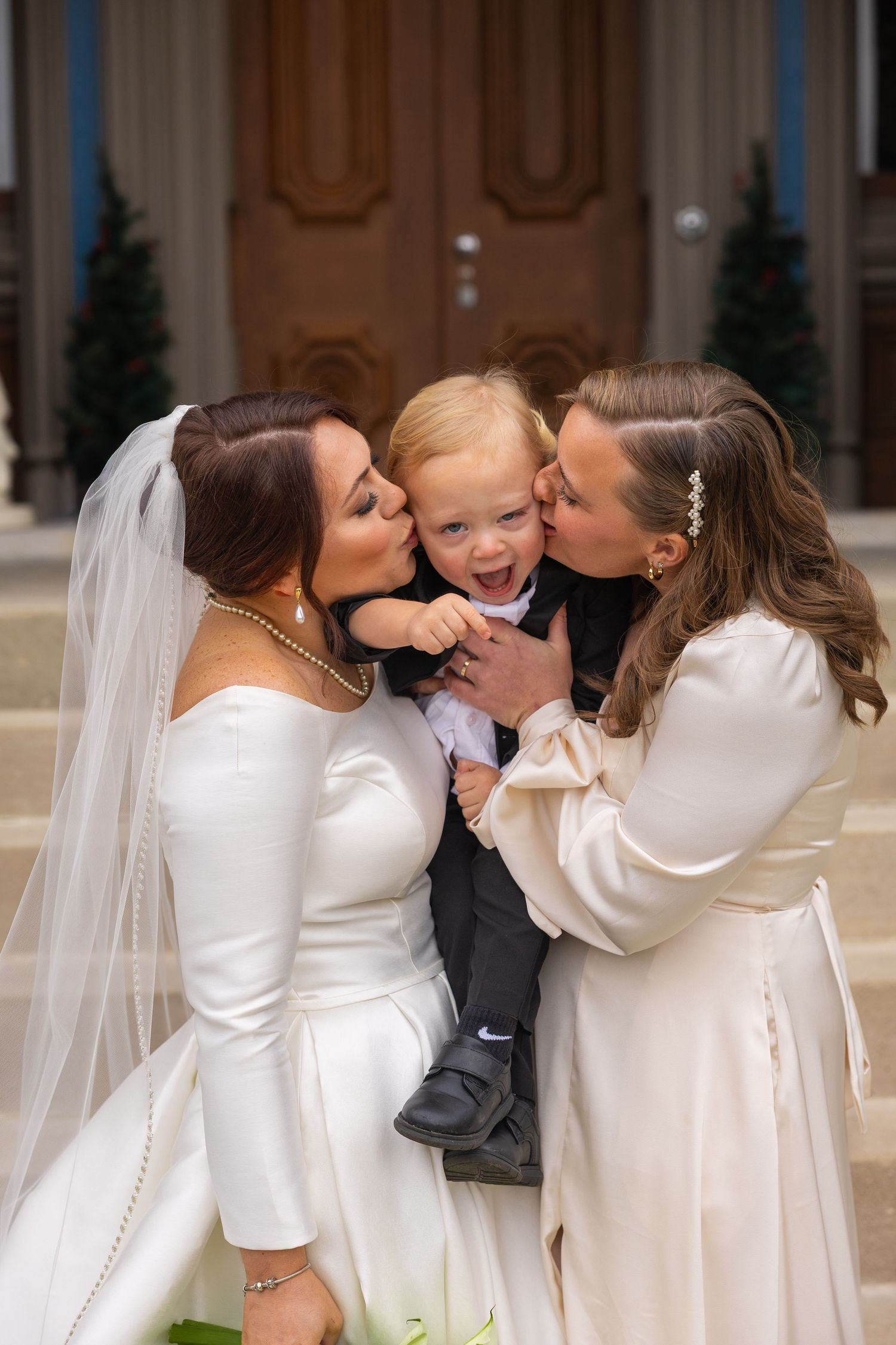 A sequence of wedding photos showing tender moments between a bride and child in formal attire.