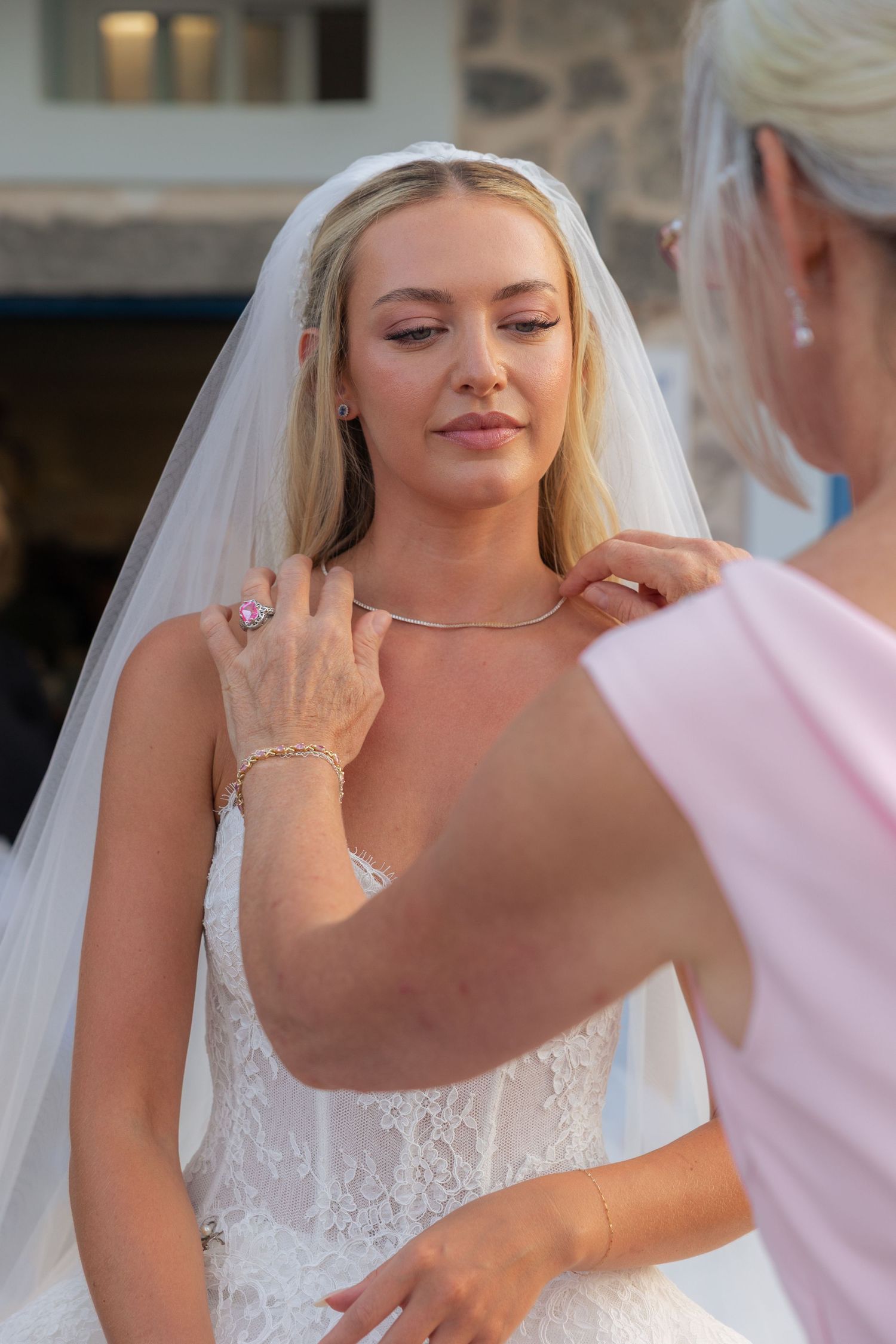 A series of close-up shots showing final bridal preparations with delicate makeup application in soft lighting.