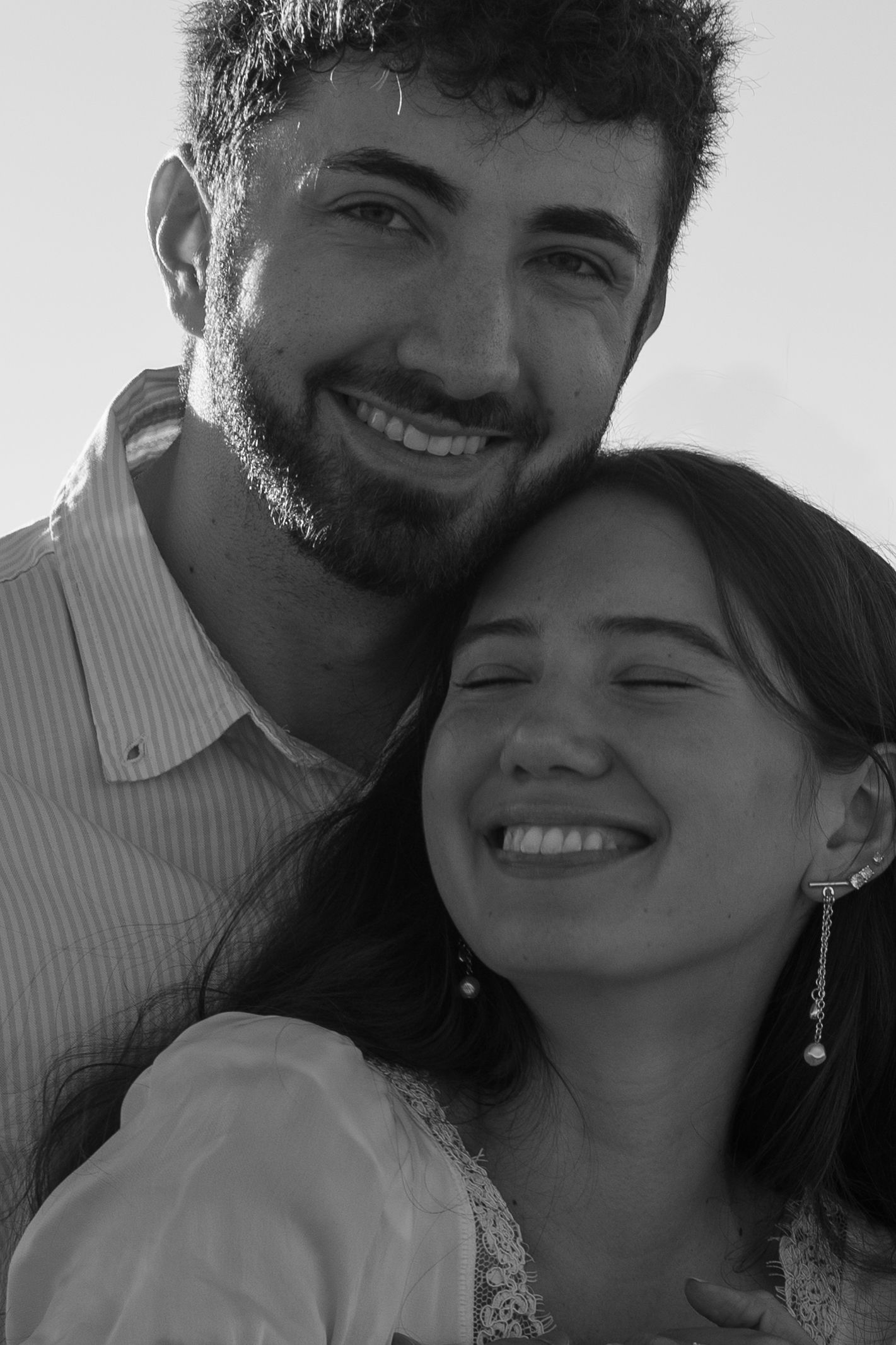 A black and white photo series showing a happy couple sharing intimate moments and smiles together.