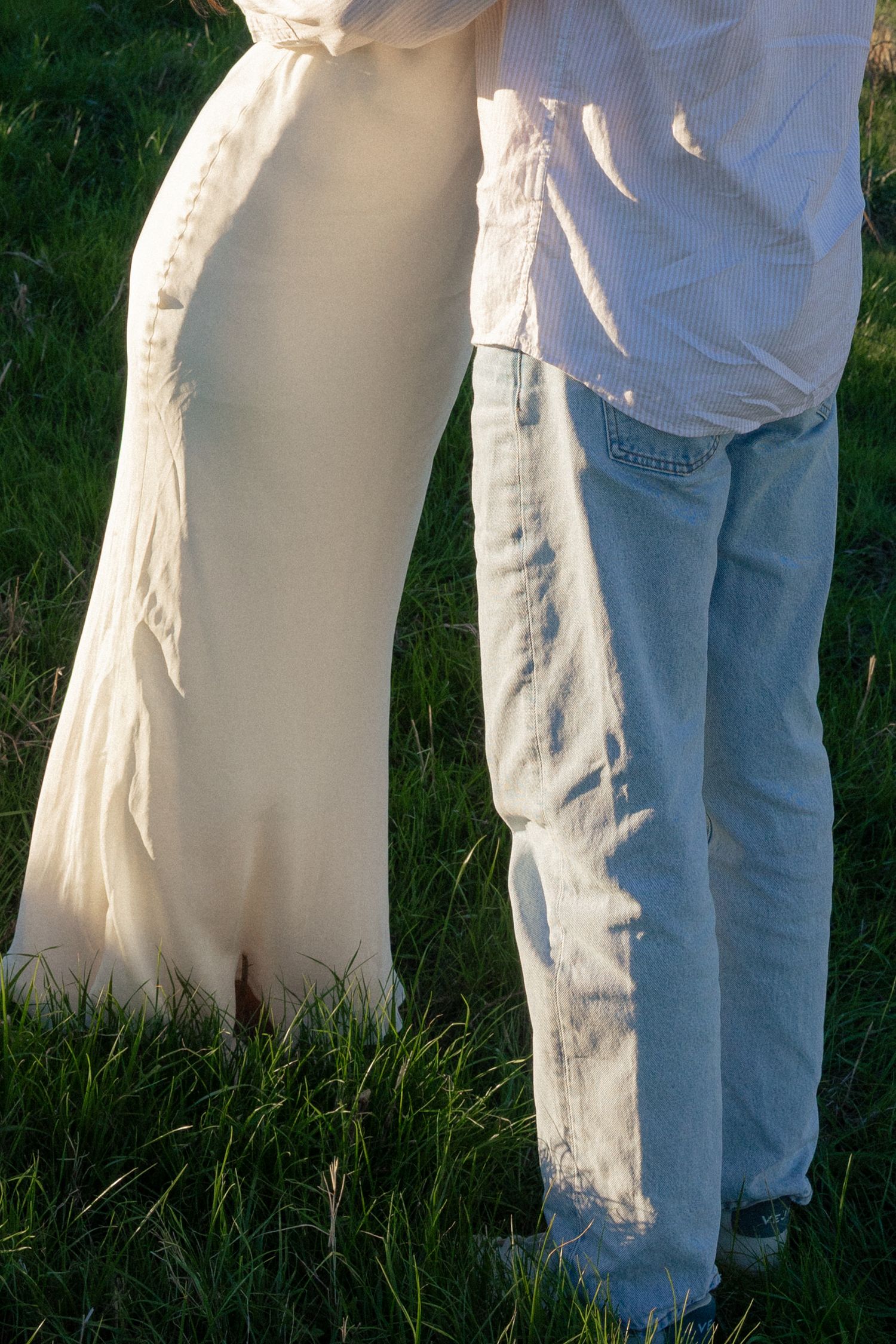A series of close-up shots showing white wedding dress fabric contrasting against blue denim jeans in an outdoor setting.
