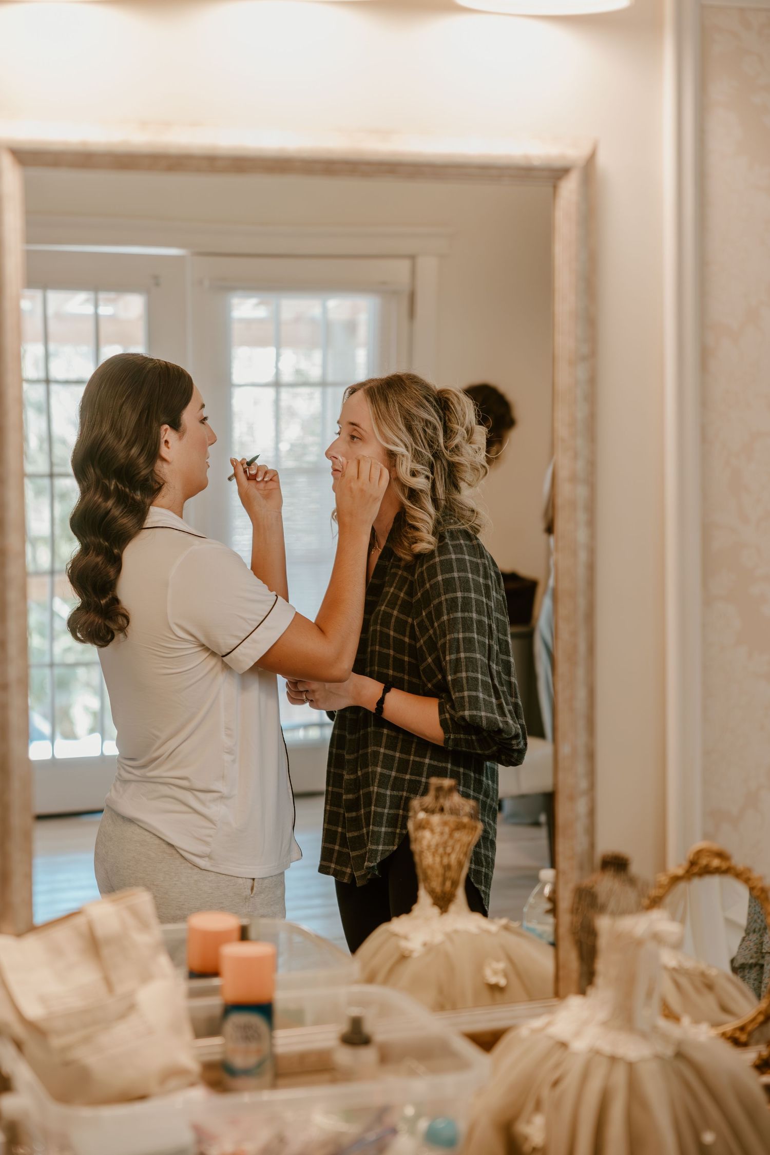 Getting ready scene in bright indoor space with makeup application preparations.