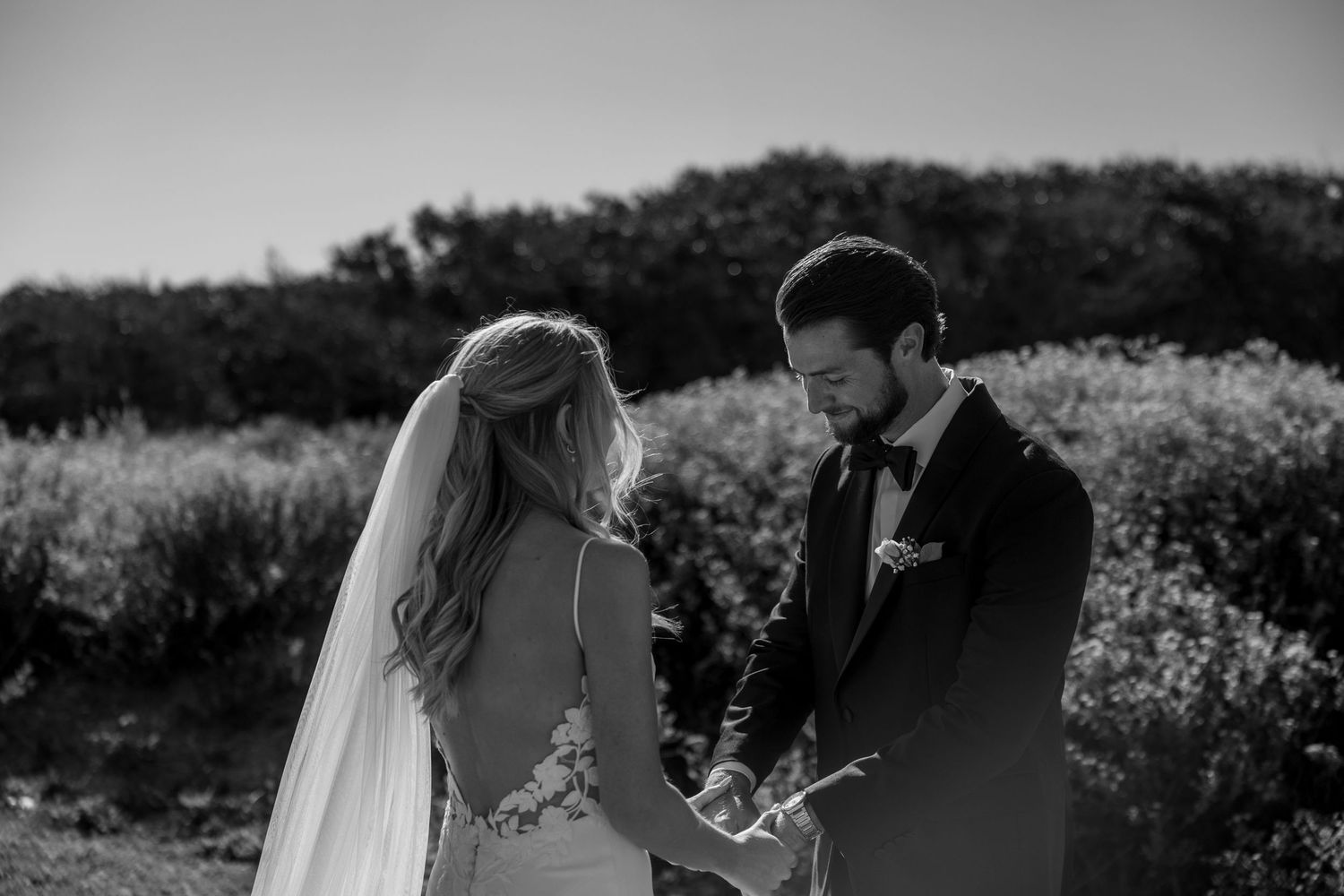 A black and white film strip sequence showing an outdoor wedding ceremony in a natural setting.