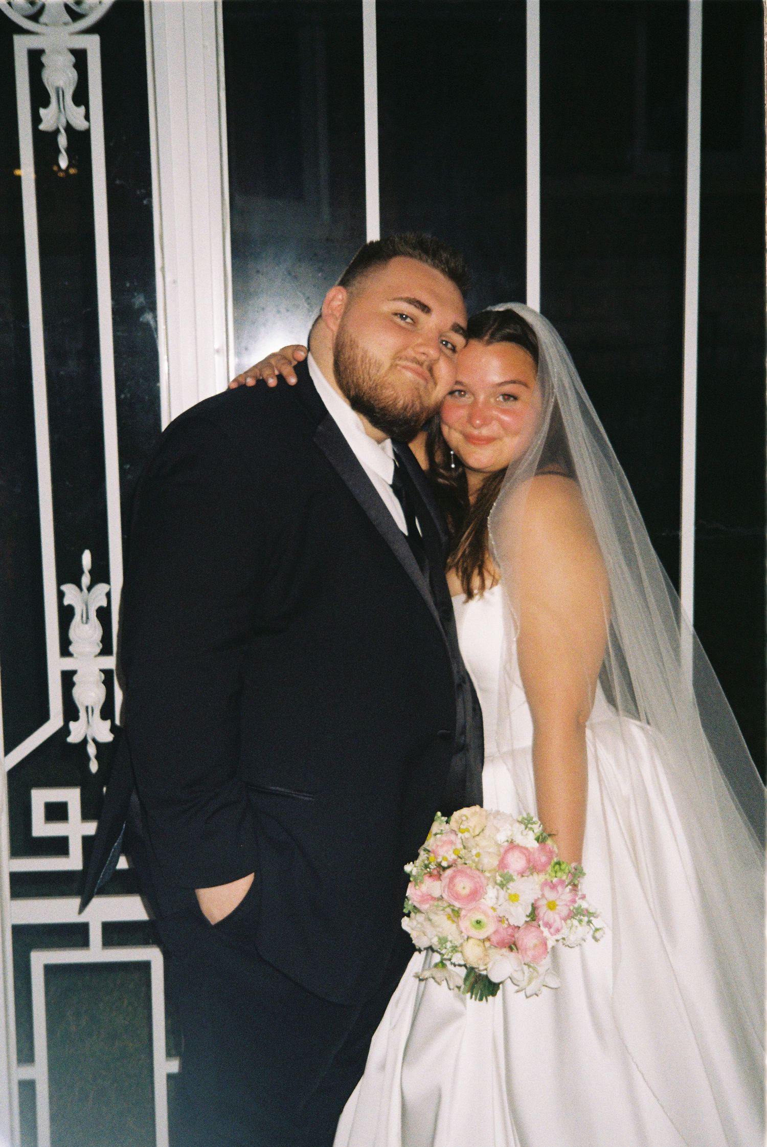 A bride and groom share romantic moments in three candid wedding photos against a dark iron gate background.